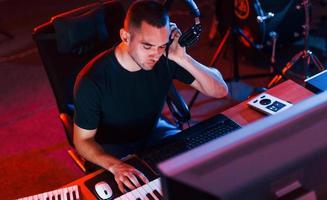 Sound engineer working and mixing music indoors in the studio photo