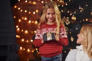 Mother and daughter with gifts celebrating christmas holidays together photo