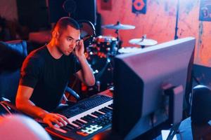 Sound engineer working and mixing music indoors in the studio photo