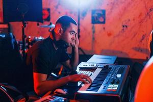 Sound engineer working and mixing music indoors in the studio photo