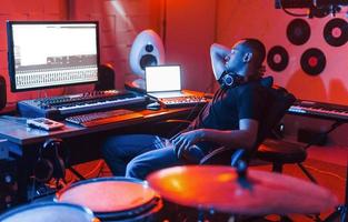 Guy have a job with project and mixing music indoors in the studio photo