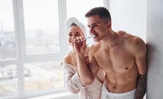 Couple at morning rime after the shower standing together photo