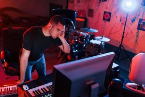 ingeniero de sonido profesional trabajando y mezclando música en interiores en el estudio foto