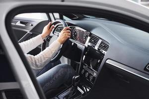 Particle view of man in formal wear that riding brand new car photo