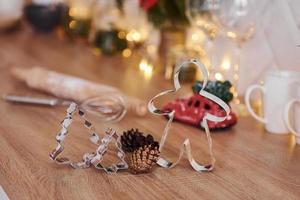 Glasses and x-mas decorations in the room. Bright garlands and lights photo