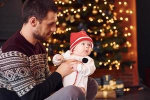 Father with his child together in christmas decorated room photo