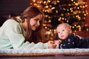 Mother with her child together in christmas decorated room photo