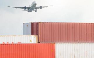 Air logistics. Cargo airplane flying above stack of logistic container. Cargo and shipping business. Container ship for export logistic. Logistic industry from port to port. Freight transportation. photo