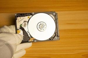 top view mechanic holding hard drive photo