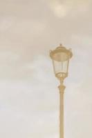 Street lamp. Reflection in a puddle against a cloudy sky in cloudy weather. Blurry image photo