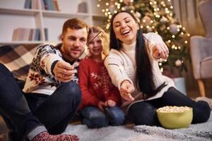 Happy family indoors in christmas decorated room have fun together and celebrating new year photo