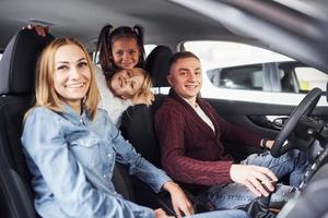 Cheerful family riding in a car together. Having fun and good weekend photo