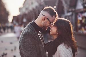 Happy multiracial couple together outdoors in the city. Asian girl with her caucasian boyfriend photo