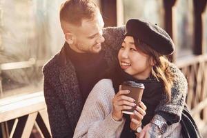 Happy multiracial couple together outdoors in the city. Asian girl with her caucasian boyfriend photo