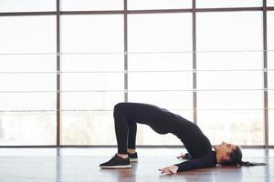 Young sporty woman in sportswear doing fitness in the gym photo