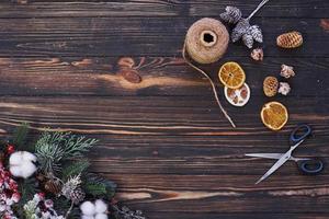 Scissors on the table. Top view of christmas festive frame with new year decorations photo