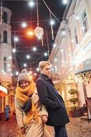 Couple have a walk together on the christmas decorated street photo