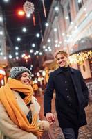 Couple have a walk together on the christmas decorated street photo