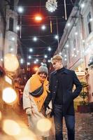 Couple have a walk together on the christmas decorated street photo