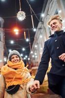 Couple have a walk together on the christmas decorated street photo