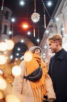 Couple have a walk together on the christmas decorated street photo