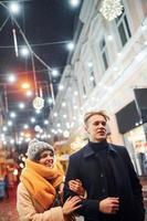 Couple have a walk together on the christmas decorated street photo