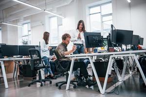 Group of young business people that working by computers in the modern office photo