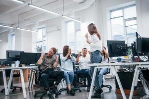 People talking and working together in the modern office near computers photo