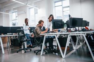 grupo de jóvenes empresarios que trabajan con computadoras en la oficina moderna foto