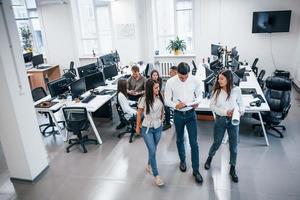 Group of young business people that standing and sitting and working in the office photo