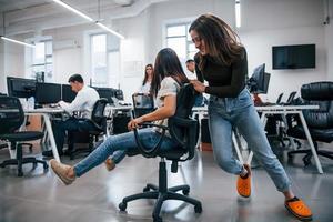 Positive young people have fun at break time in the office photo