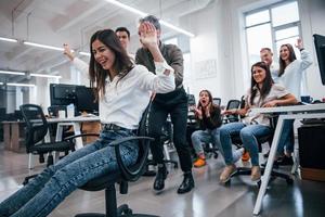 Positive young people have fun at break time in the office photo