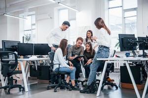 Group of young business people that standing and sitting and working in the office photo