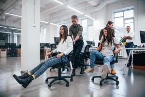 Positive young people have fun at break time in the office photo