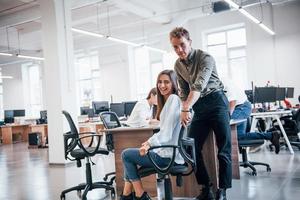 Positive young people have fun at break time in the office photo