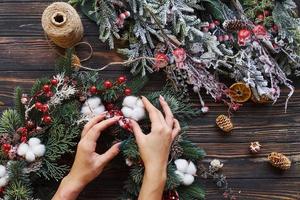 Woman taking care of ornament. Top view of christmas festive frame with new year decorations photo