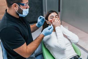 Scared woman have a visit in the dentist clinic. Conception of stomatology photo