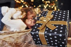 Mother with her little daughter celebrating christmas with presents photo