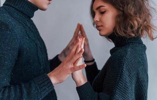 Cute young couple embracing each other indoors in the studio photo