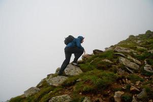 tourist walking through rocky land photo