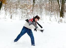 man playing snowballs photo