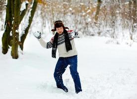 man playing snowballs photo