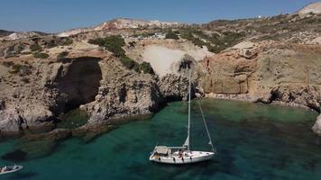 Tsigrado Beach and Sail Boat Aerial View in Milos, Cyclades Island in Aegean Sea, Greece video