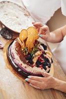 Close up view of woman with fresh dietical cake on the kitchen photo