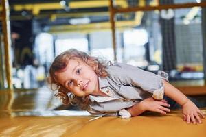 Child sitting in playroom. Kindergarten educational games photo