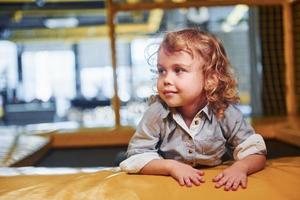 Child sitting in playroom. Kindergarten educational games photo