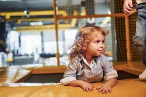 Child sitting in playroom. Kindergarten educational games photo