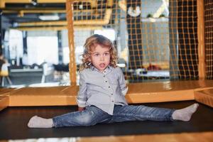 Child in casual clothes have fun in playroom at weekend time photo