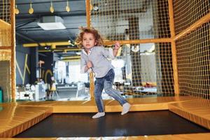 Child in casual clothes have fun in playroom at weekend time photo