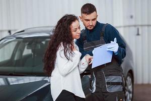 Female customer takes back her auto in car washing service photo